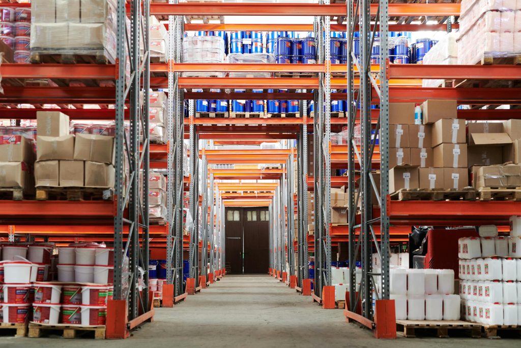 pexels-photo-4483610-4483610 Wide angle view of a warehouse with stocked shelves and boxes.